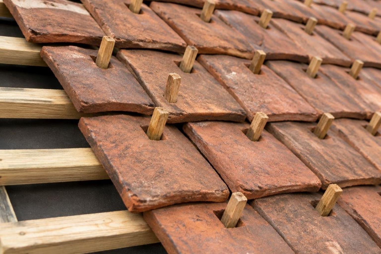 hand-split wooden oak pegs secured through clay tile holes