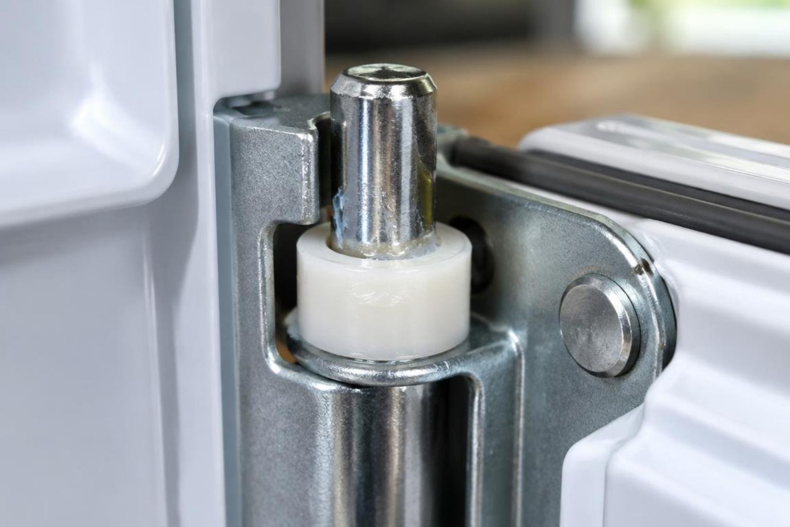 Close-up photograph of a clean, properly lubricated metal refrigerator hinge pin and nylon bushing Close-up photograph of a clean, properly lubricated metal refrigerator hinge pin and nylon bushing